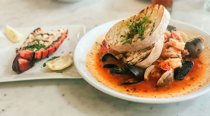 seafood dishes on white plates