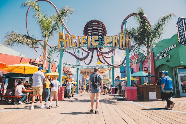 colorful amusement park entrance with palm trees