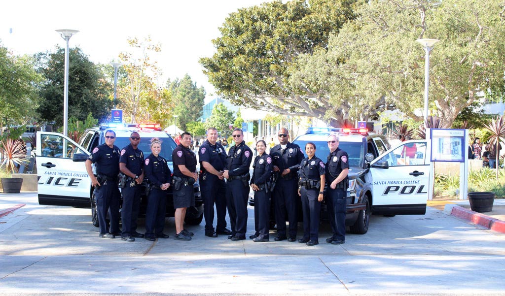 A group of policemen and policewomen pose in uniform