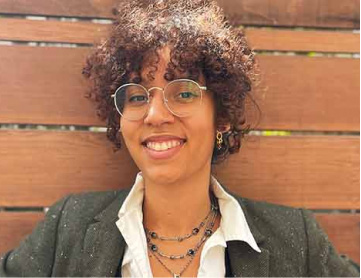 Smiling woman with glasses and curly hair