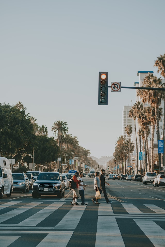 city crosswalk with tall buildings in distance 
