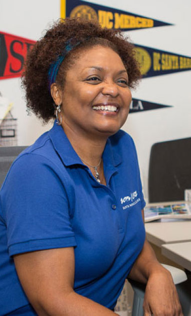 a smiling woman at a desk