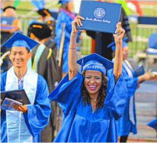 female graduate holding up diploma