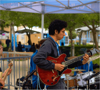 a young man playing electric guitar